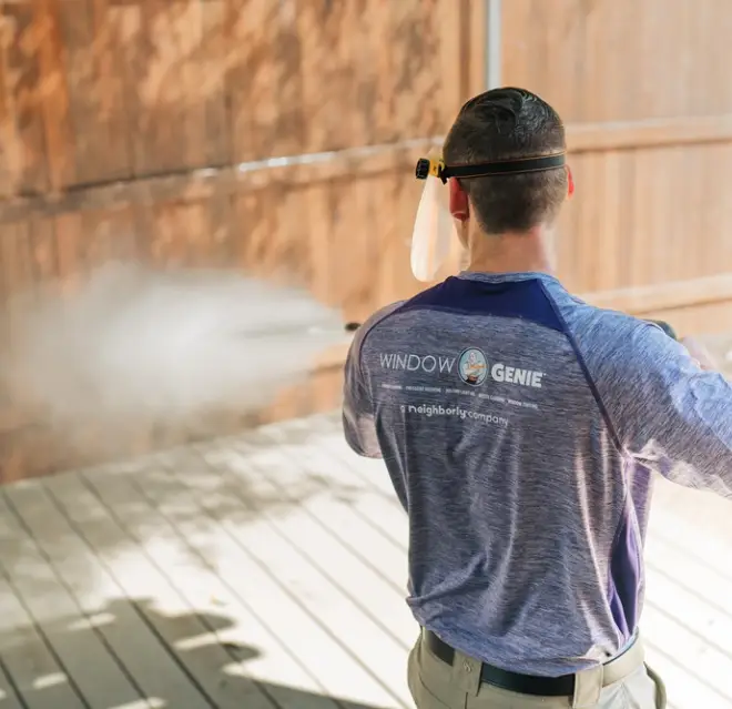 Window Genie professional cleaning a fence.