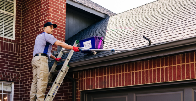 Window Genie Tech doing gutter cleaning 