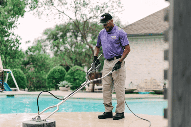 Window Genie Tech cleaning concrete at an Iowa City home. 