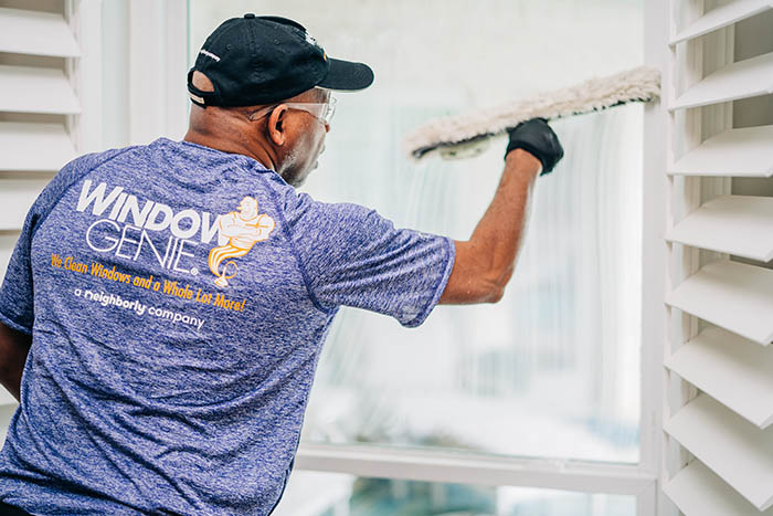 Window Genie tech doing window cleaning in customer's home.