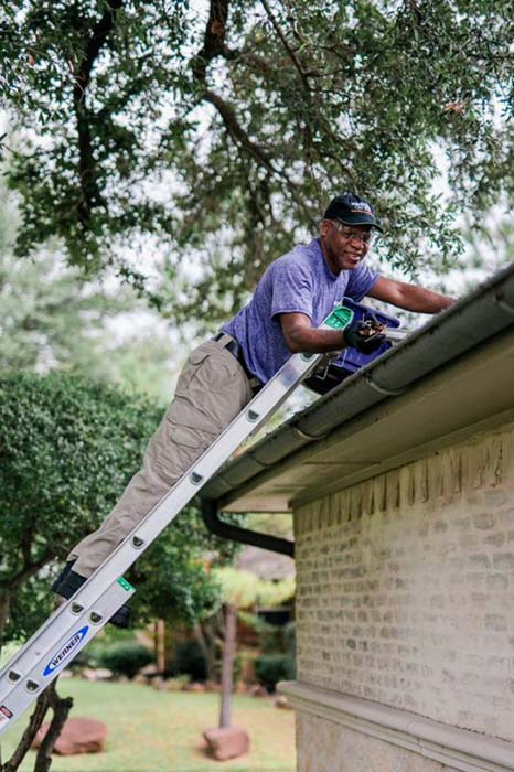 Window Genie tech performing a gutter cleaning service in Myrtle Beach. 