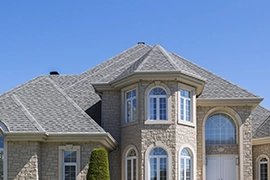 A gray roof on a large single-family home.