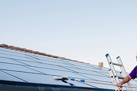 A view of solar panels against a blue sky.