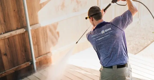 Window Genie service professional cleaning an outdoor patio. 