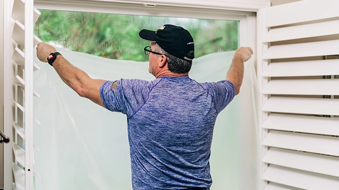 Window Genie technician installing solar window film.