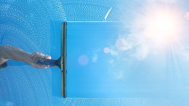 Window being cleaned with sunlight coming through.