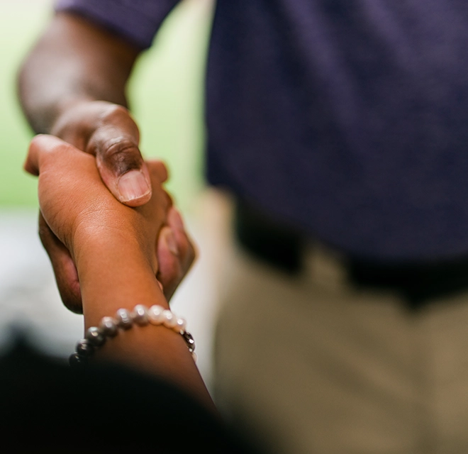 View of someone shaking hands with another person.