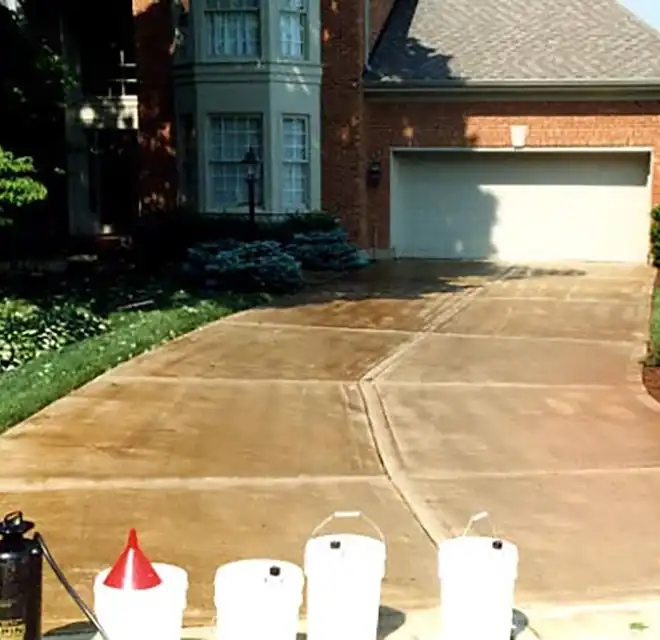 Home with freshly sealed concrete driveway.