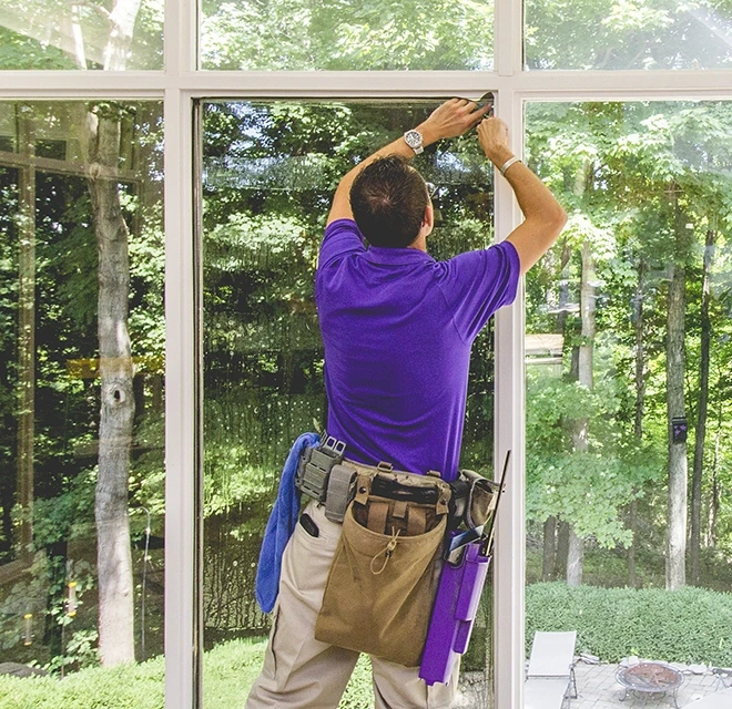 Window Genie professional removing window film.