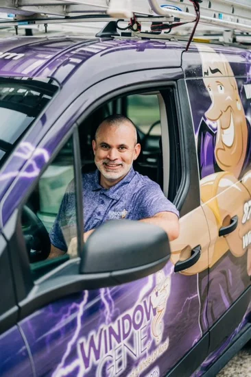 Window Genie Professional explaining window cleaning services to a customer.