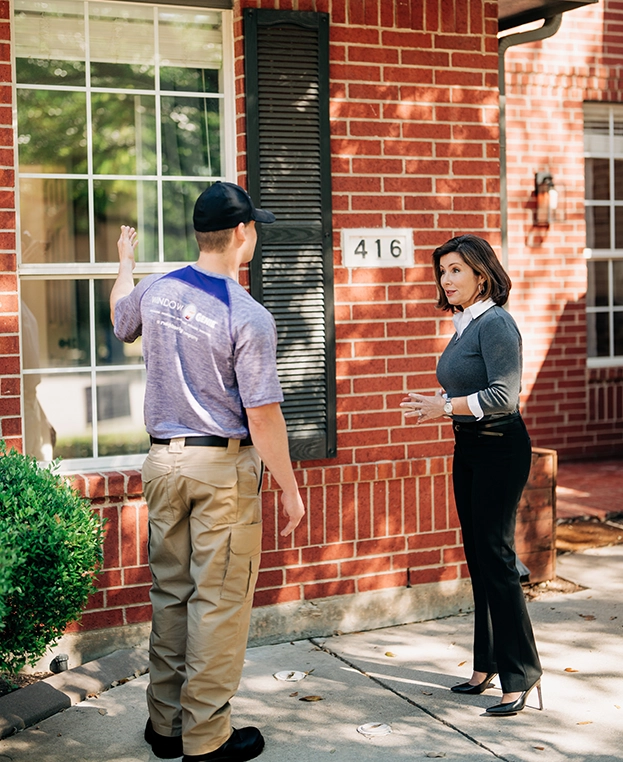 Window Genie Professional explaining window cleaning services to a customer.