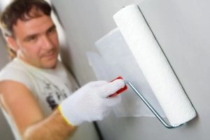 A man painting a wall.