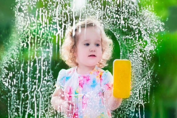 Girl cleaning glass.