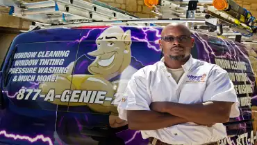 Window Genie professional in front of a service van.